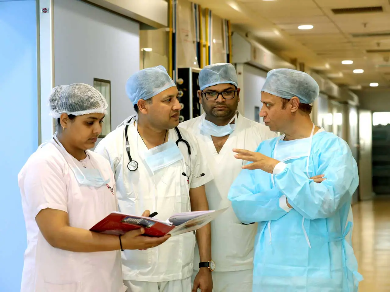Dr. Parvinder S. Lubana discussing patient treatment plans with the medical team at Apple Hospital Indore.
