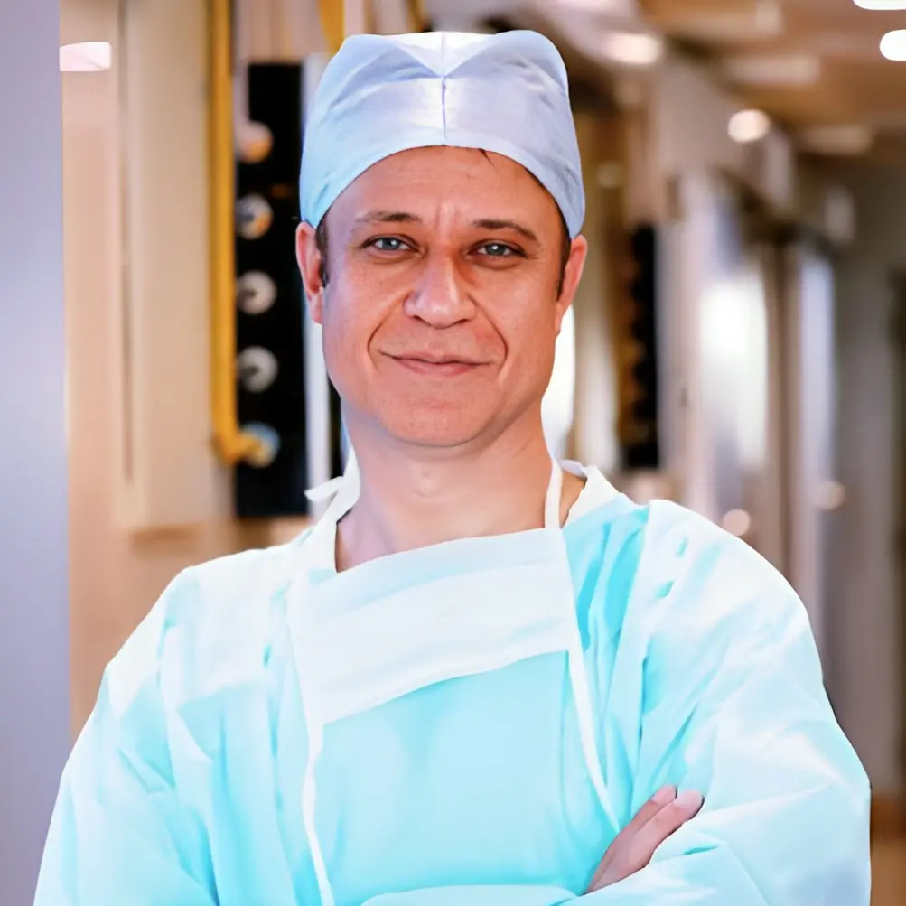 Dr. Parvinder S. Lubana portrait in surgical attire at Apple Hospital Indore.
