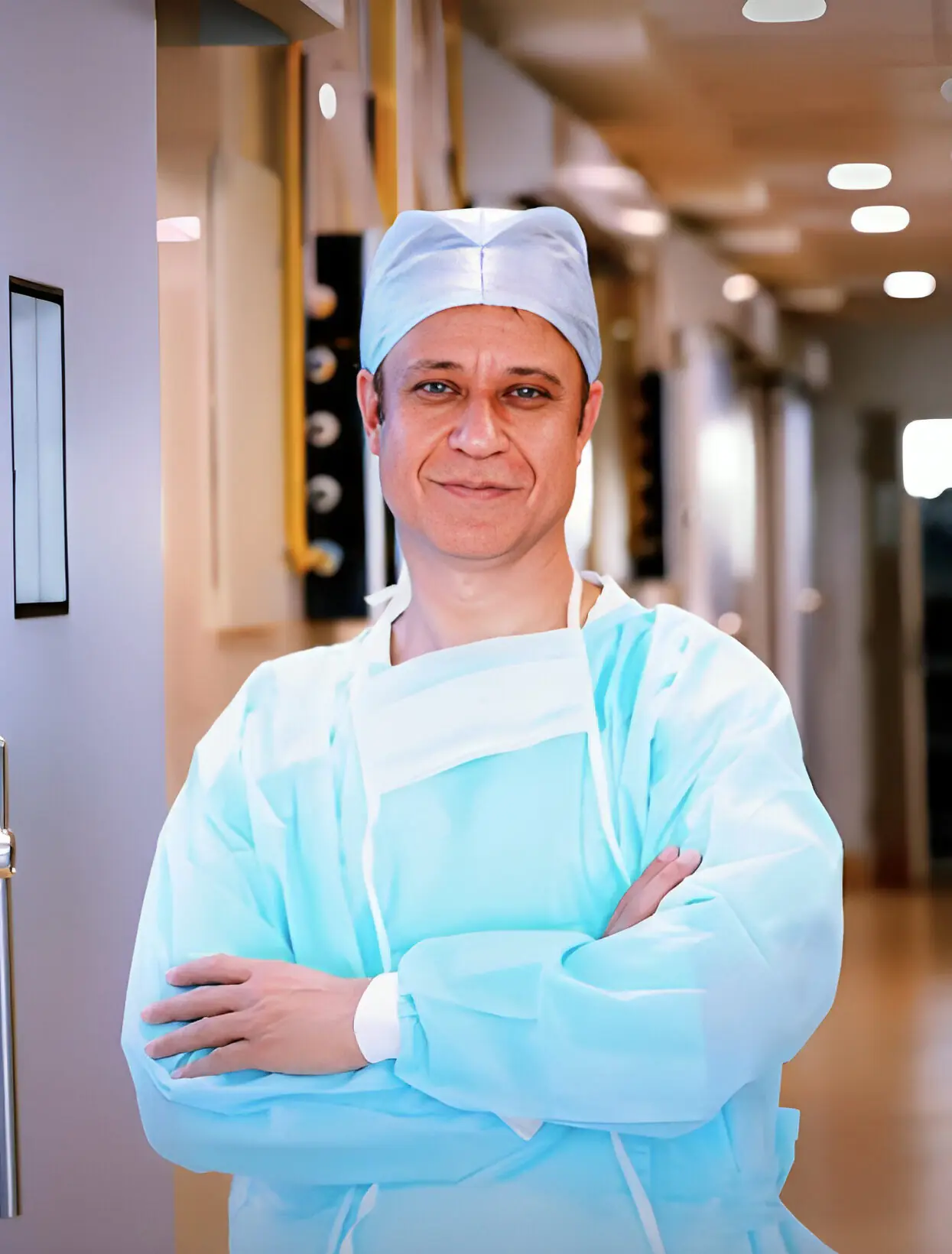 Dr. Parvinder S. Lubana standing confidently in hospital attire at Apple Hospital Indore.