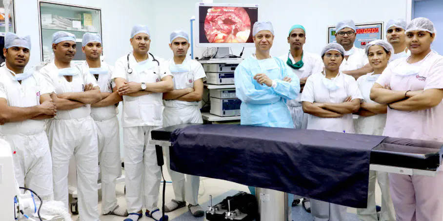 Dr. Parvinder S. Lubana with expert surgical and medical team inside a modern operation theatre at Apple Hospital Indore.